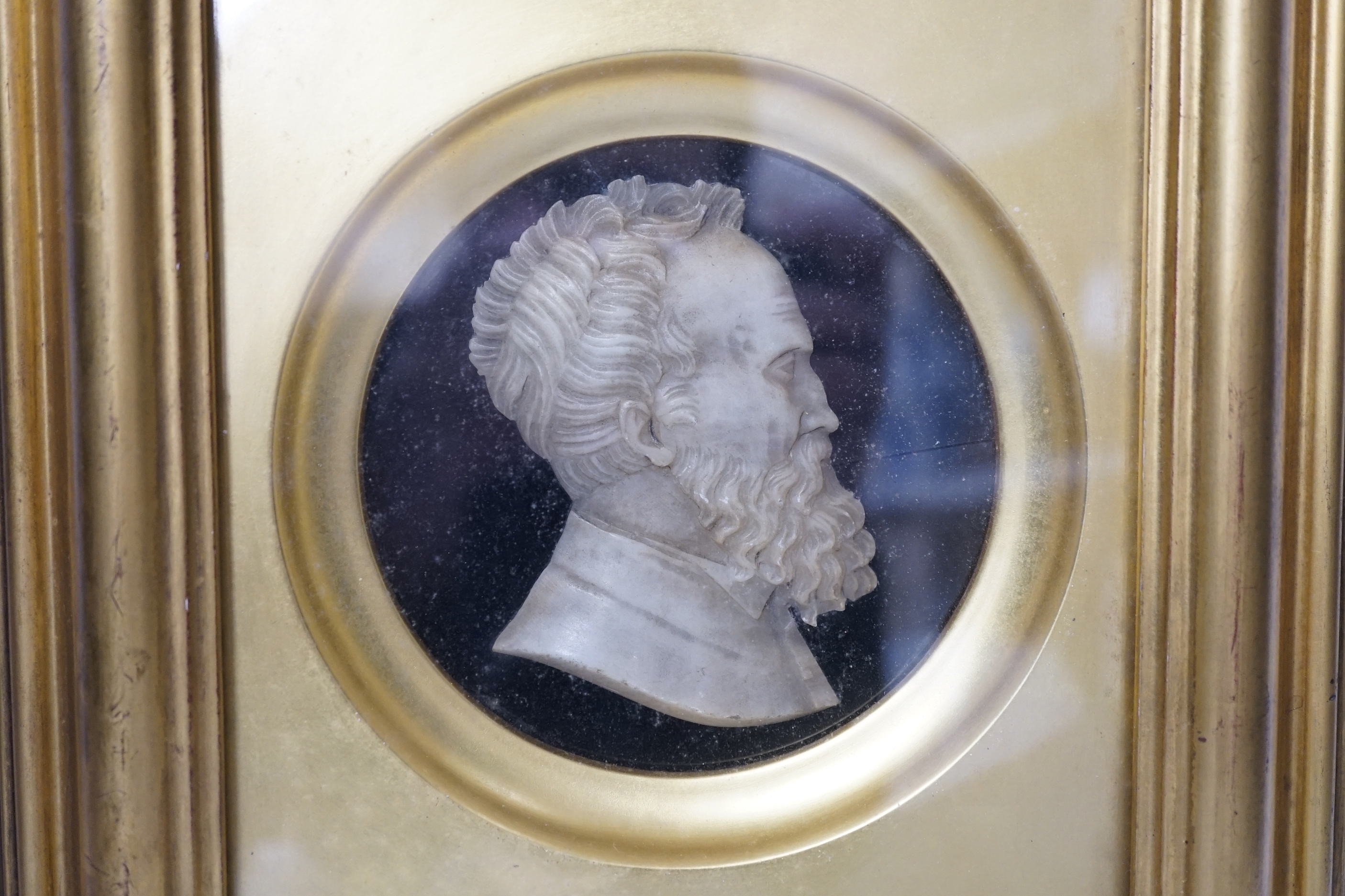 A Grand Tour carved alabaster profile bust of Michelangelo, frame 32 x 26cm